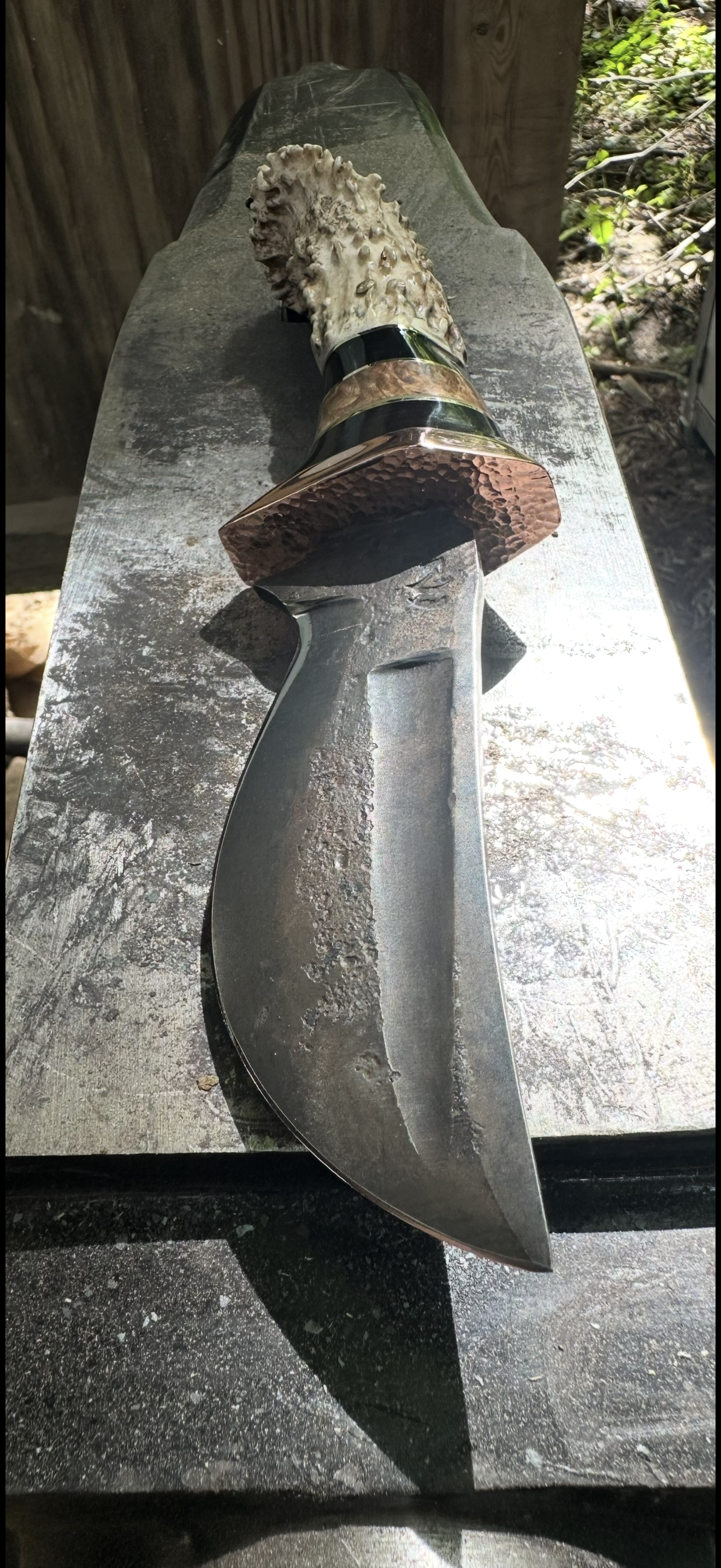 Bowie knife with antler handle on slate