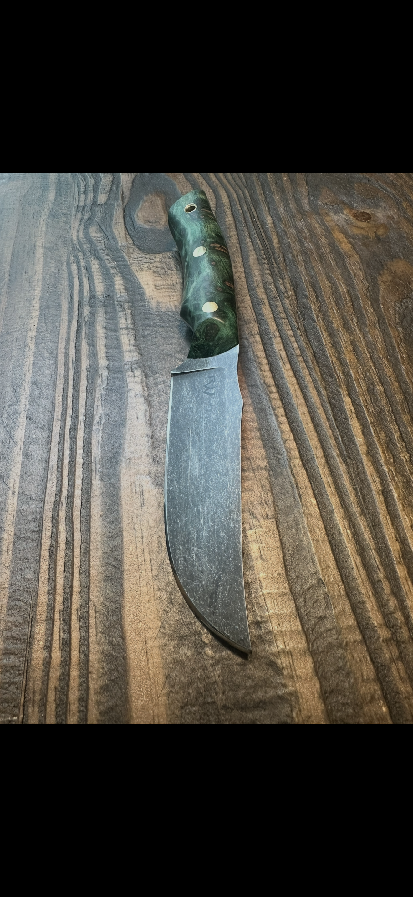 Hunter with green stabilized handle on wood