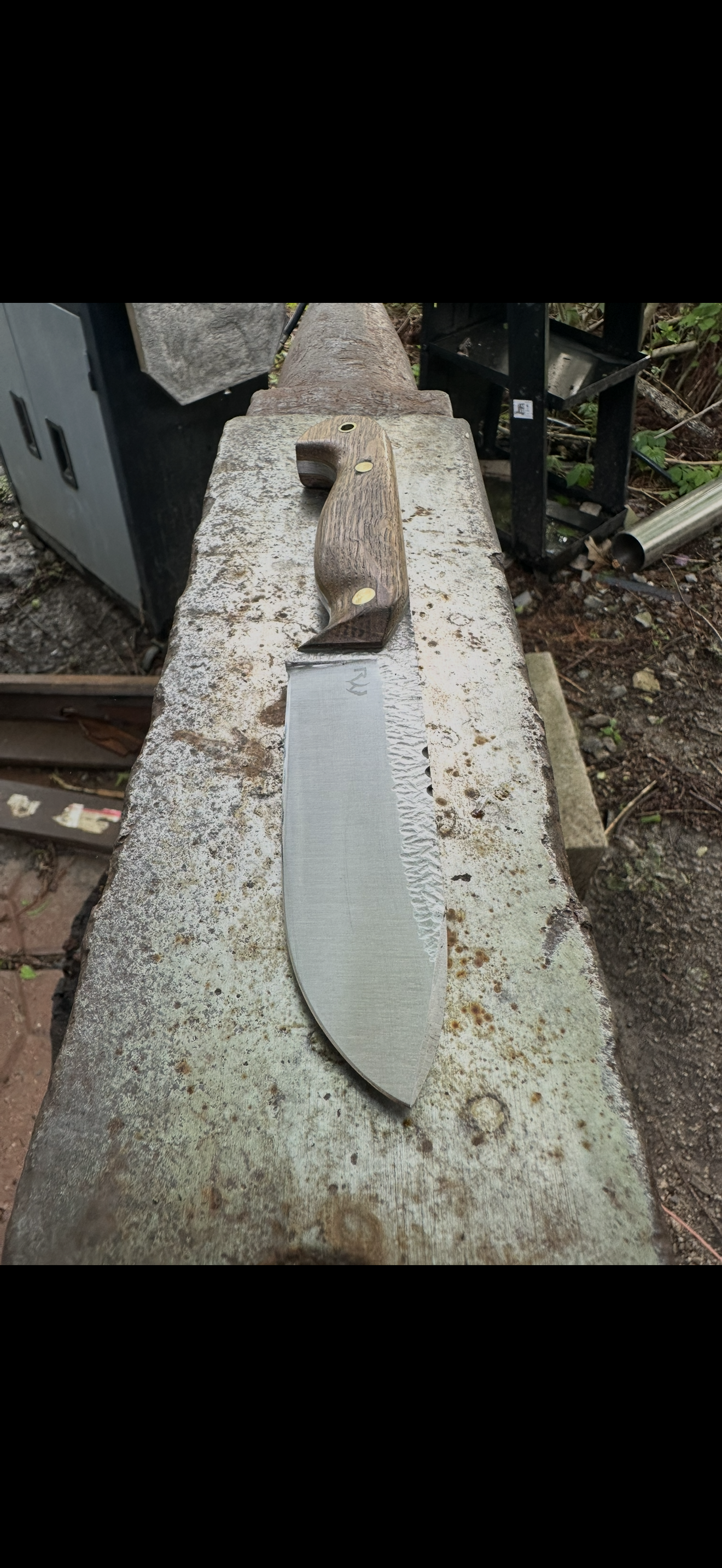 Large camp knife on concrete surface