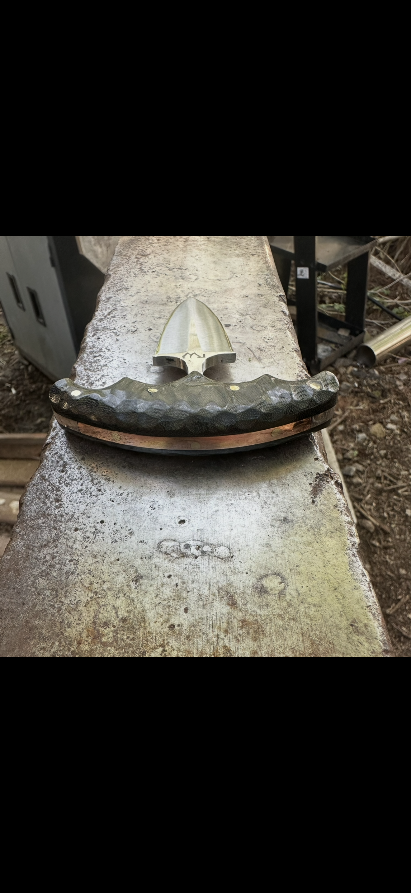 Hammered steel blade guard on concrete ledge